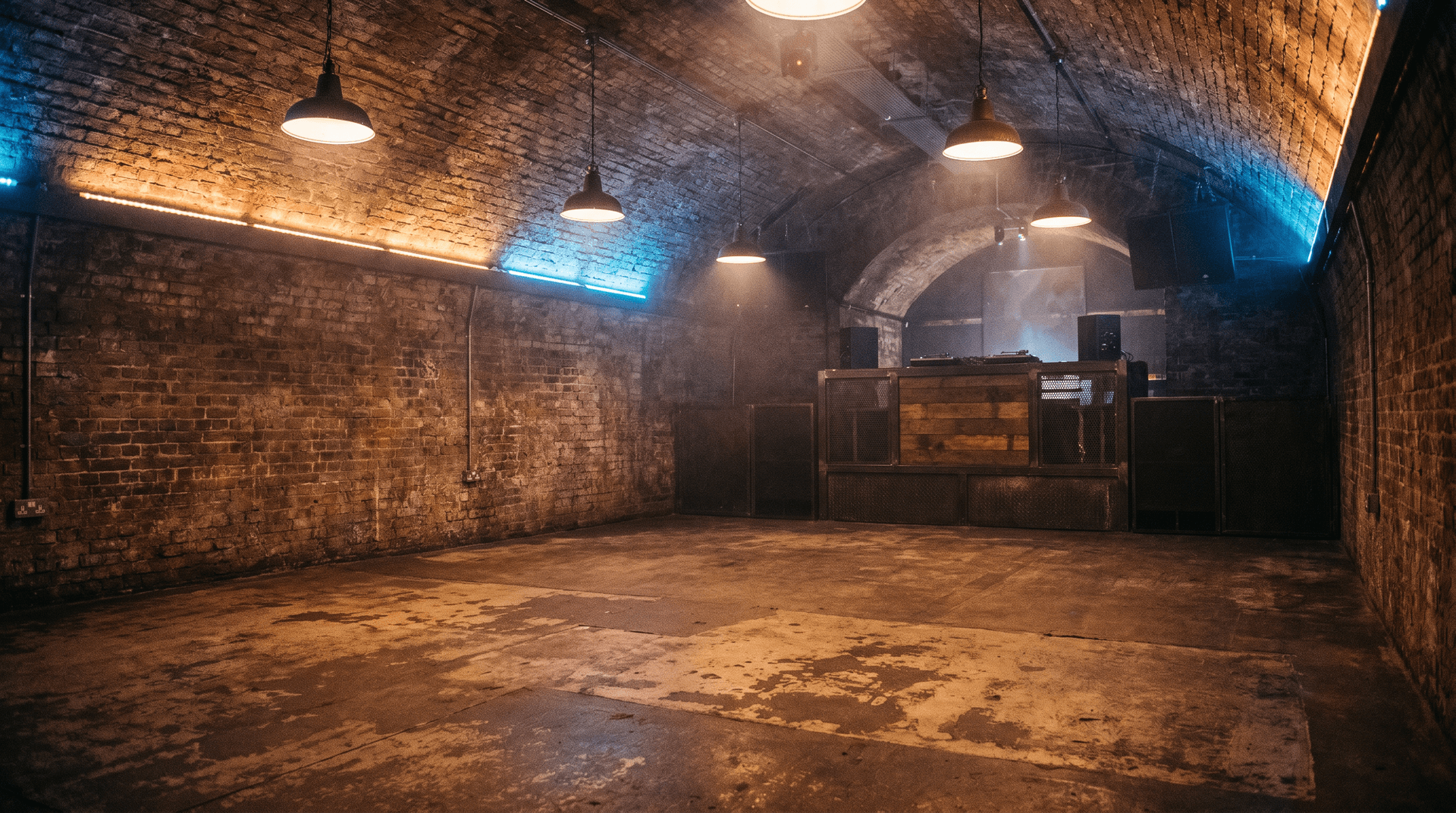 Dark underground club interior with industrial railway arches and minimal lighting
