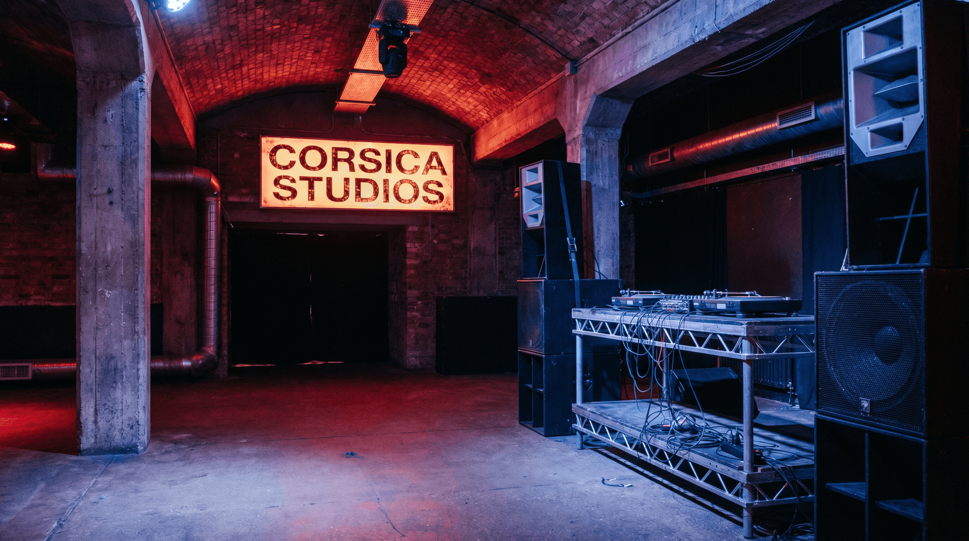 Empty nightclub interior with industrial architecture and distinctive red lighting