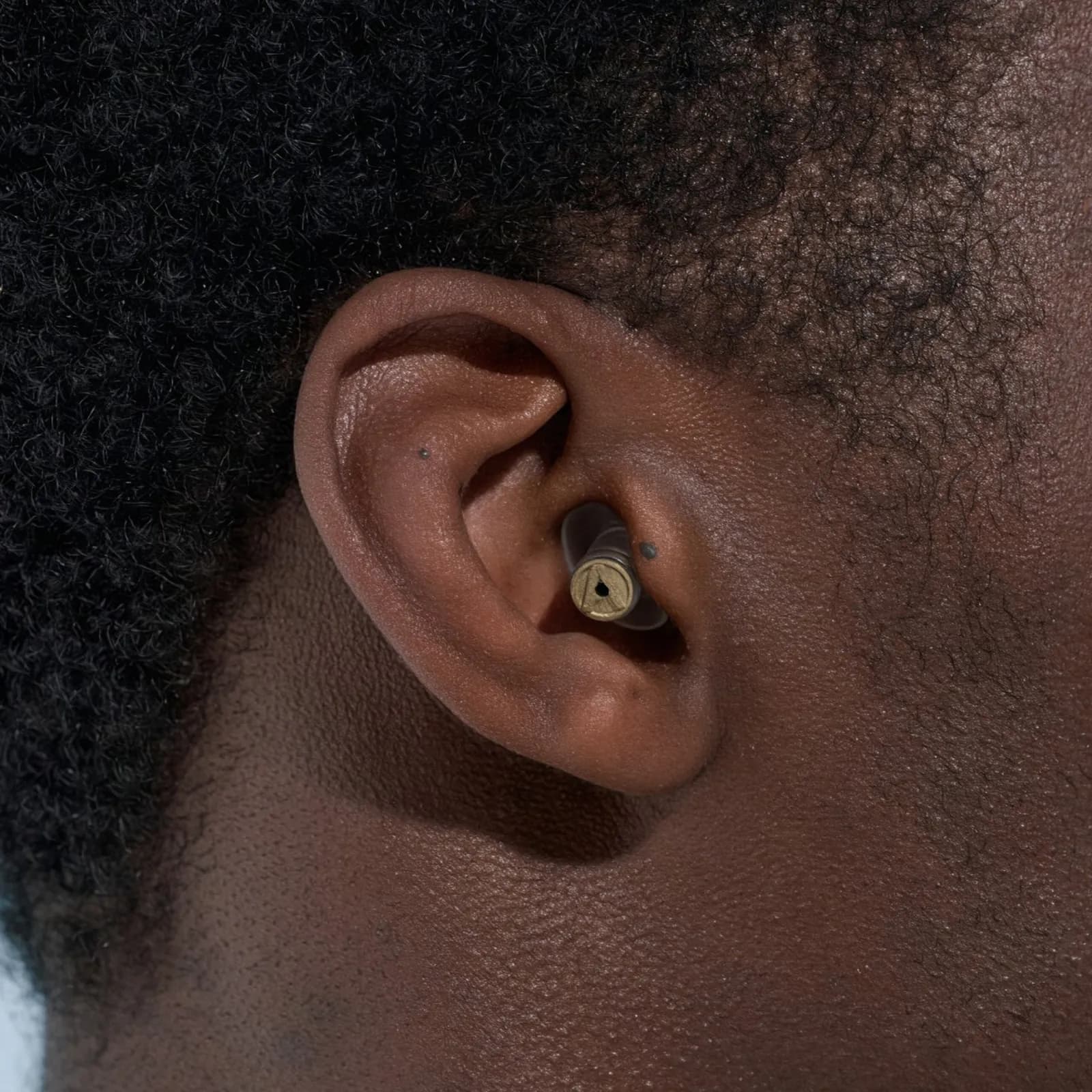 An Alpine MusicSafe Pro earplug worn in the ear