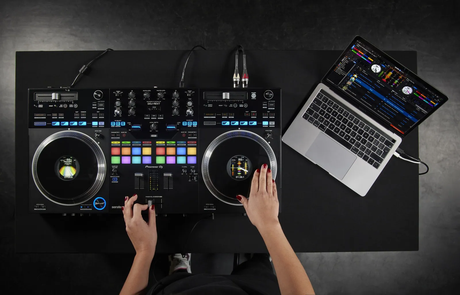 Hands on both jog wheels of a Pioneer DJ DDJ-REV7, seen from above