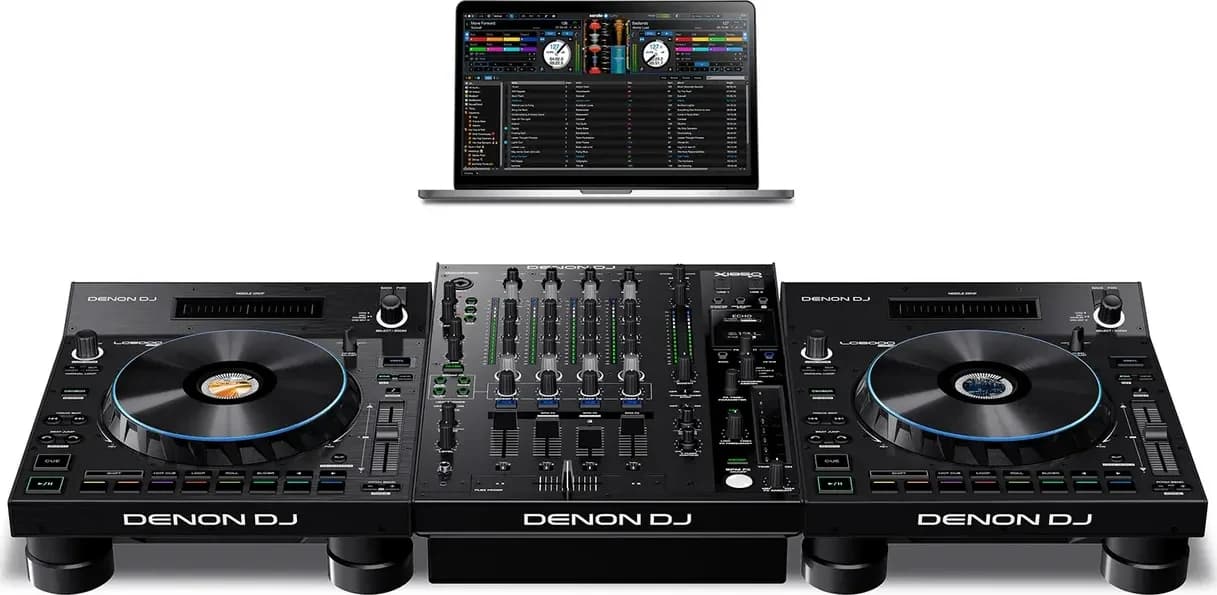Two Denon DJ LC6000 PRIME controllers either side of a DJ mixer with a laptop