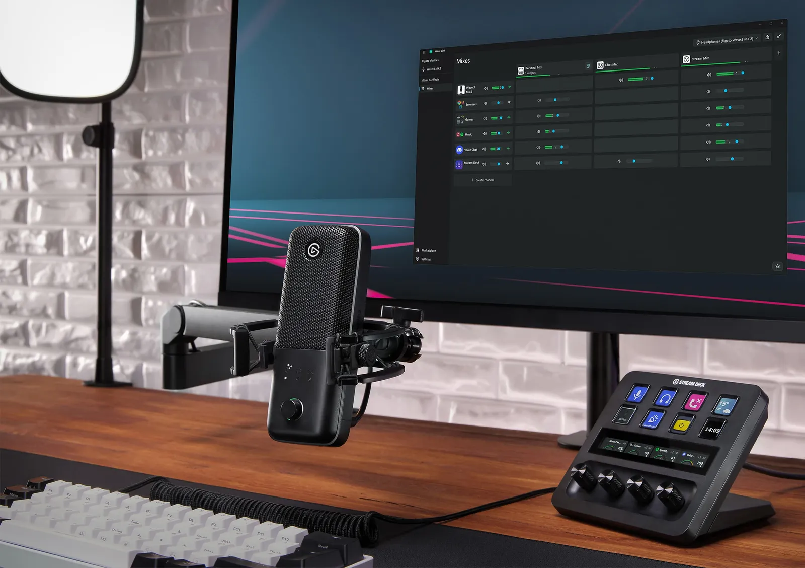 An Elgato Wave:3 MK.2 on a boom arm beside a monitor and Stream Deck