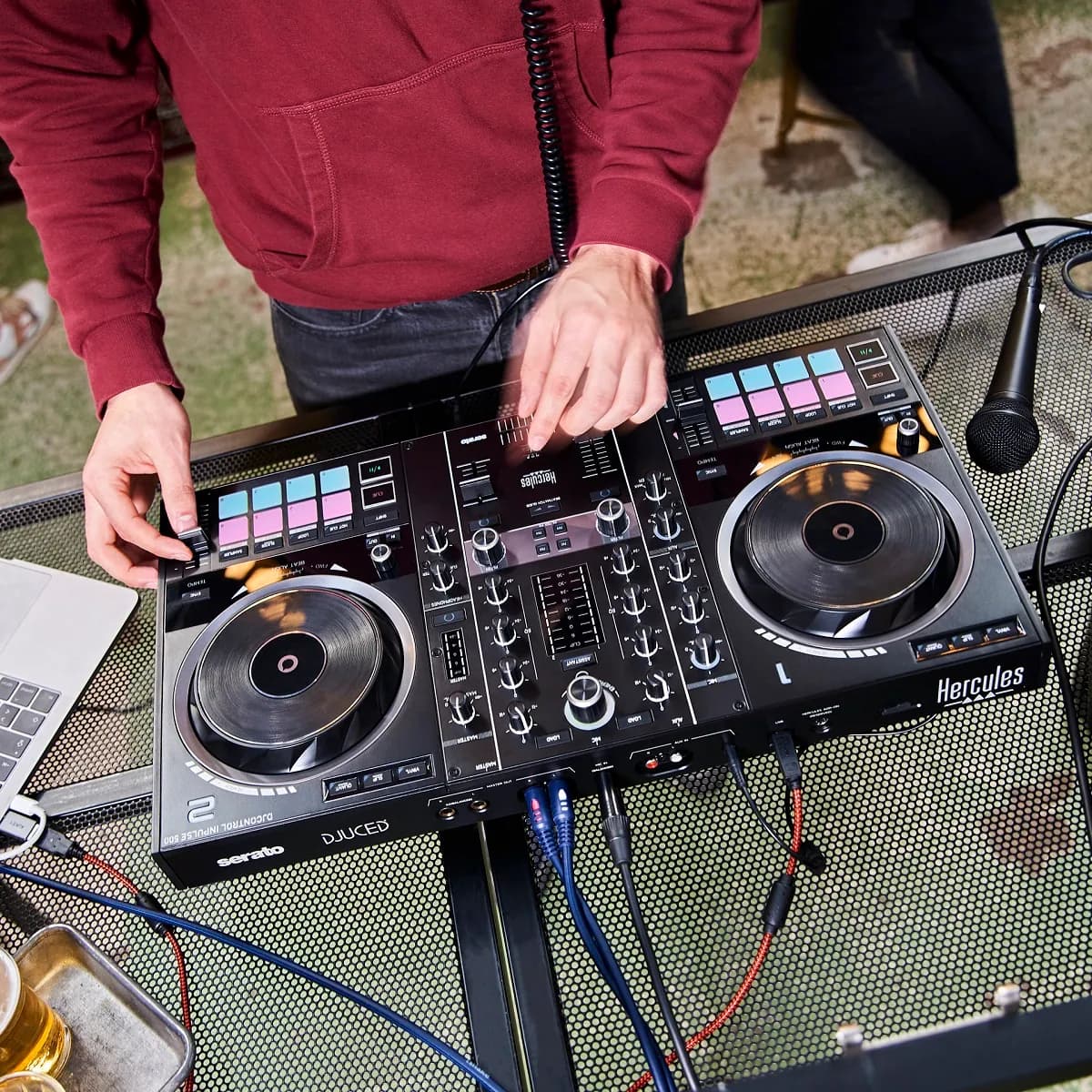 A DJ playing a Hercules DJControl Inpulse 500, seen from above