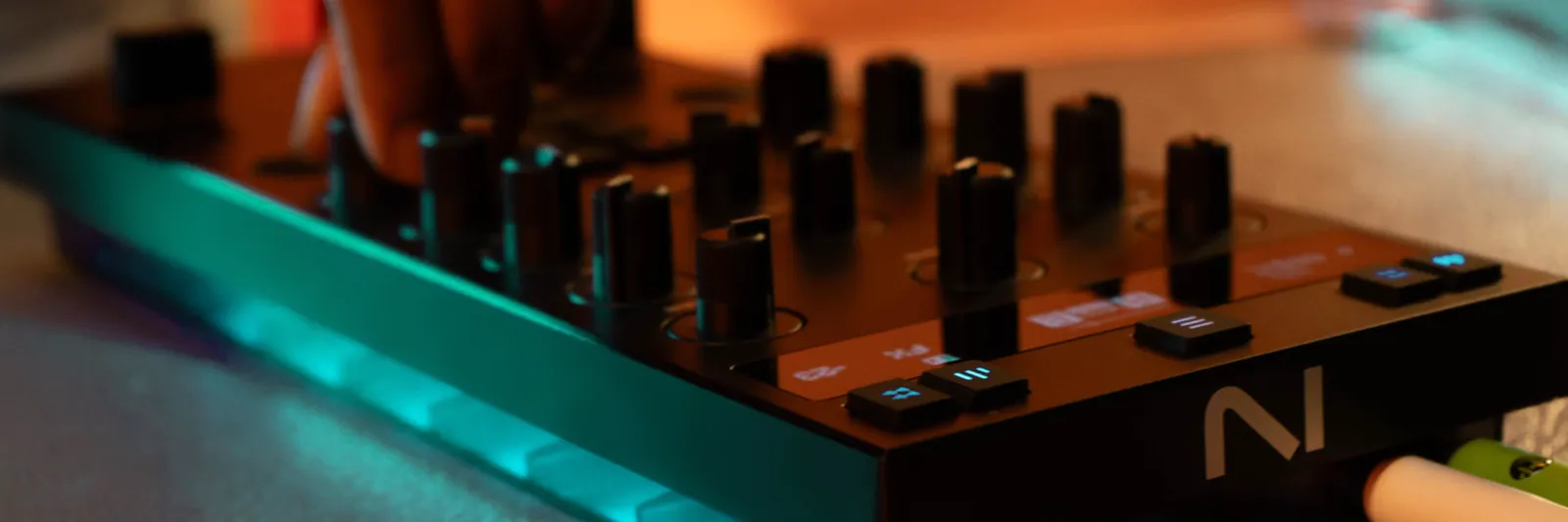 A hand on the faders of a Traktor Z1 MK2