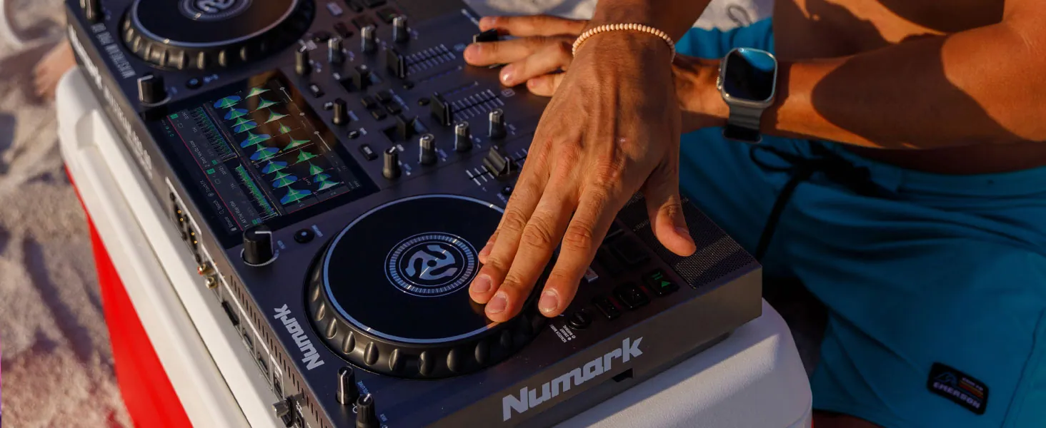 Hands on the jog wheel of a Numark Mixstream Pro Go outdoors