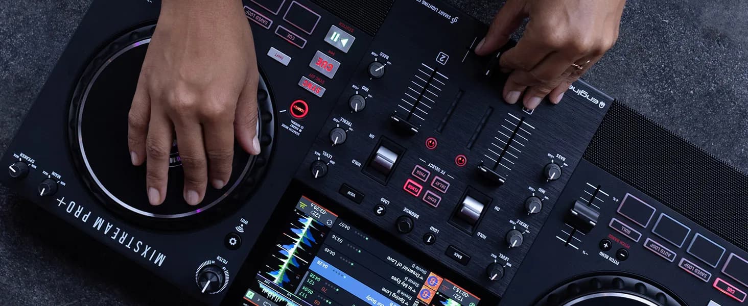 Hands on the jog wheel and mixer of a Numark Mixstream Pro+