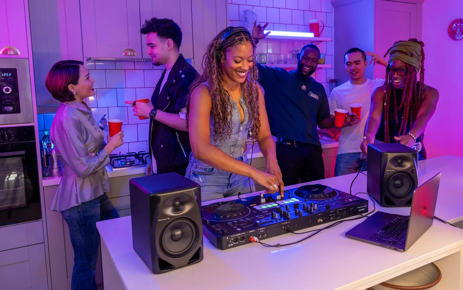 A DJ playing a Pioneer DJ DDJ-REV5 at a kitchen party
