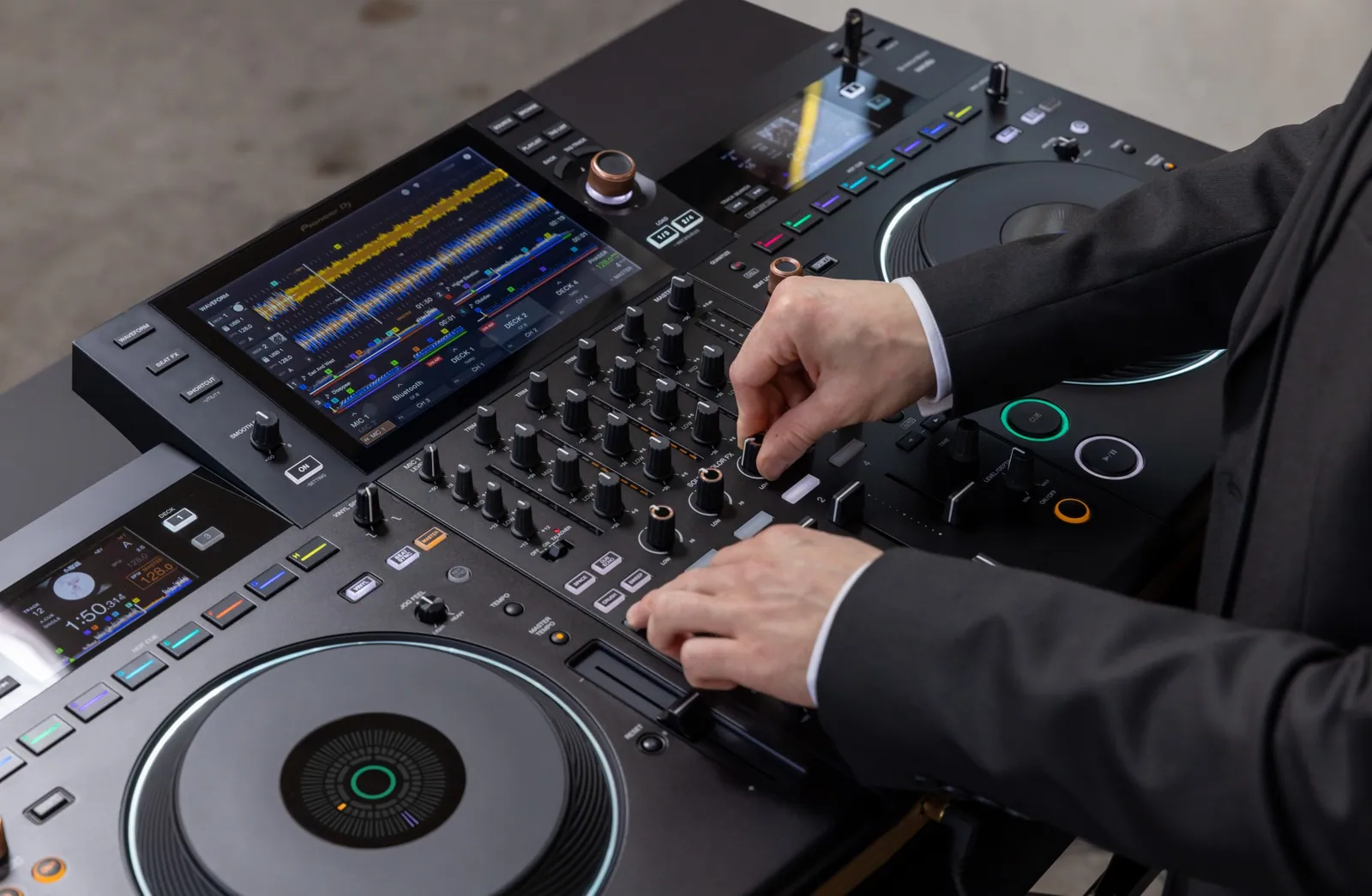 Hands on the mixer section of a Pioneer DJ OPUS-QUAD