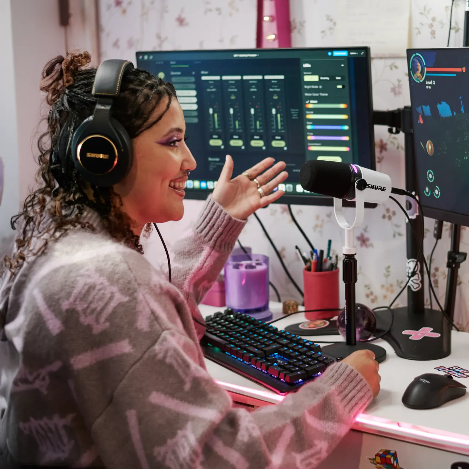 A streamer at a desk with a white Shure MV7+ on a desktop stand, MOTIV Mix on screen